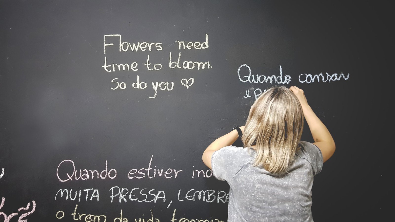 person writing on chalkboard