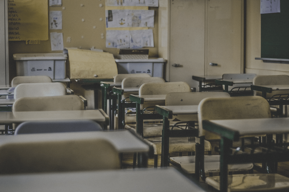 Classroom filled with rows of empty desks.