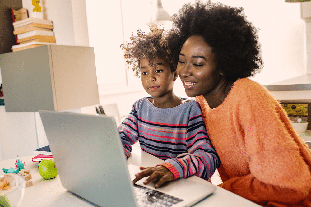 Mother and son look at a computer