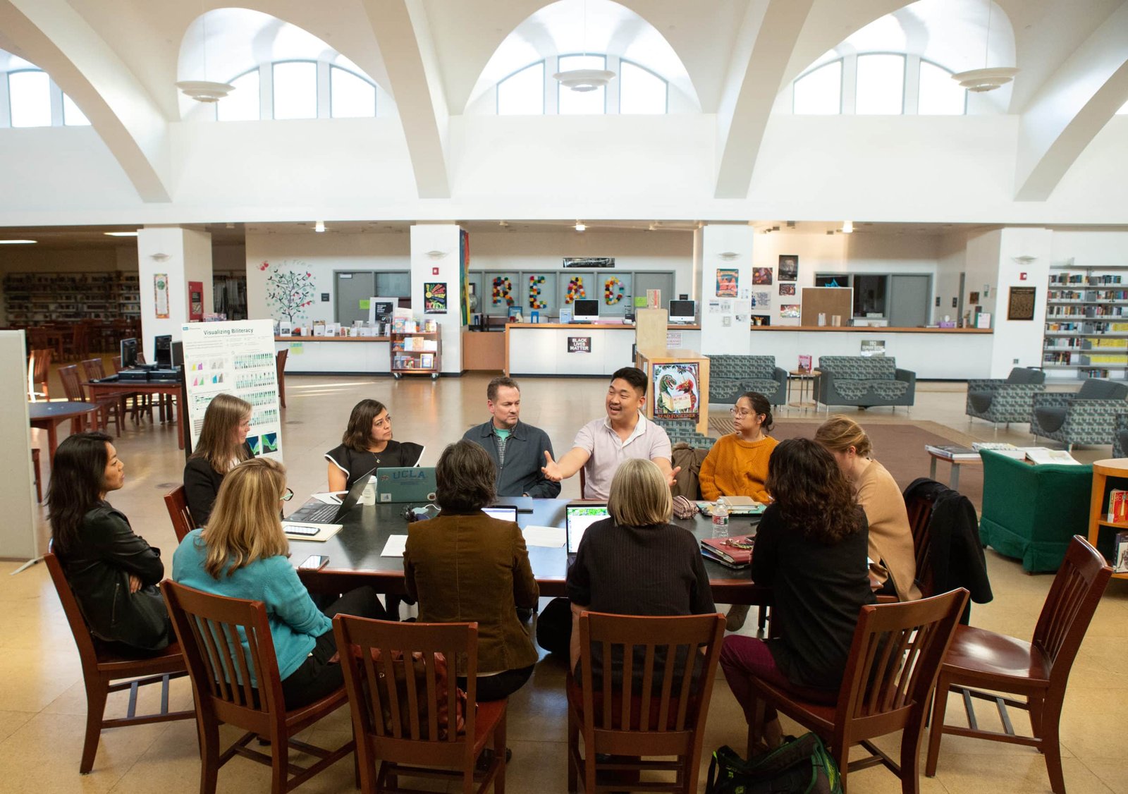 A group of adults sitting around a table talking