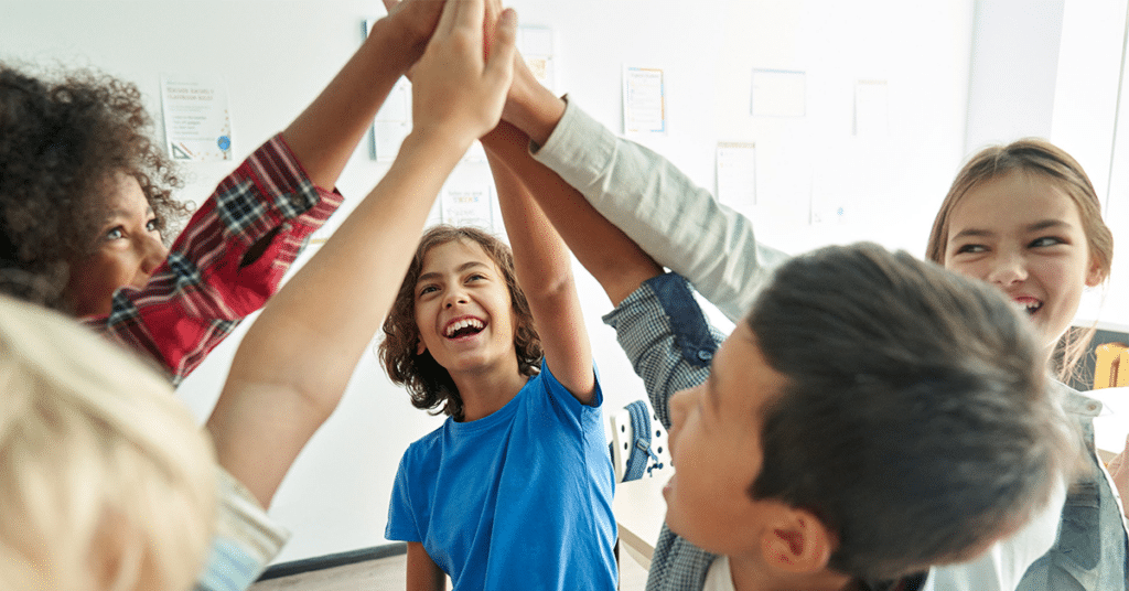 5 Students high fiving each other