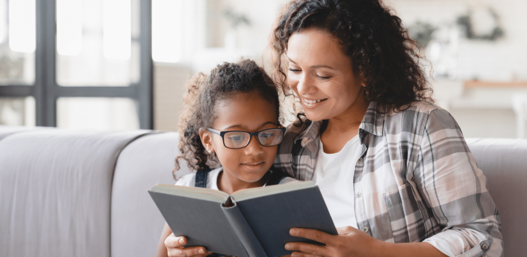 adult and child reading a book together