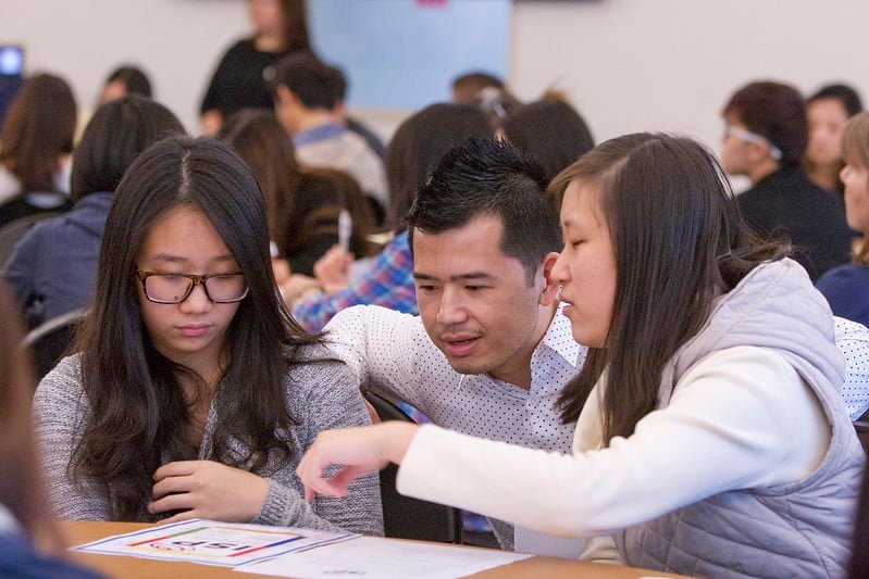 three students talking
