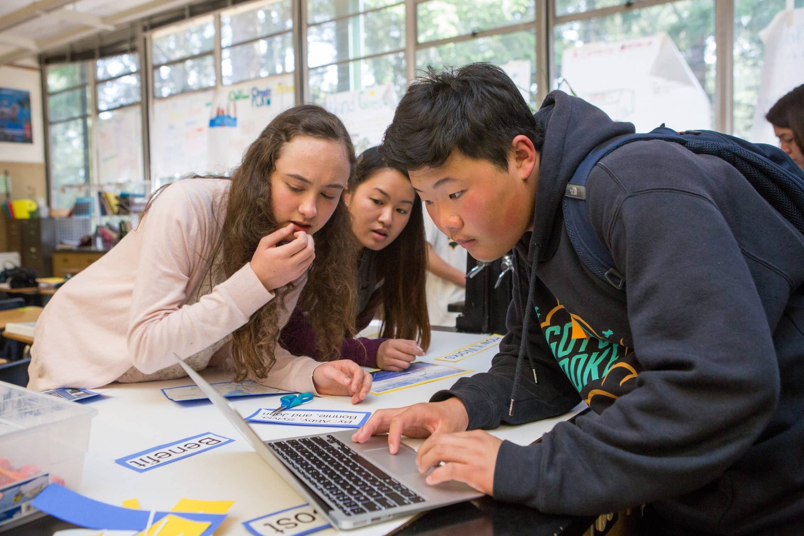 Three high school students in science class