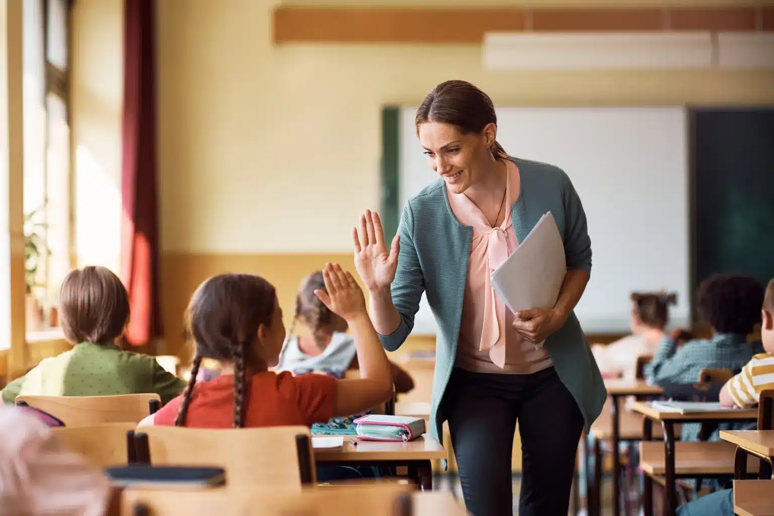 teacher high-fiving student