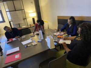 New Champions sitting around a table writing 