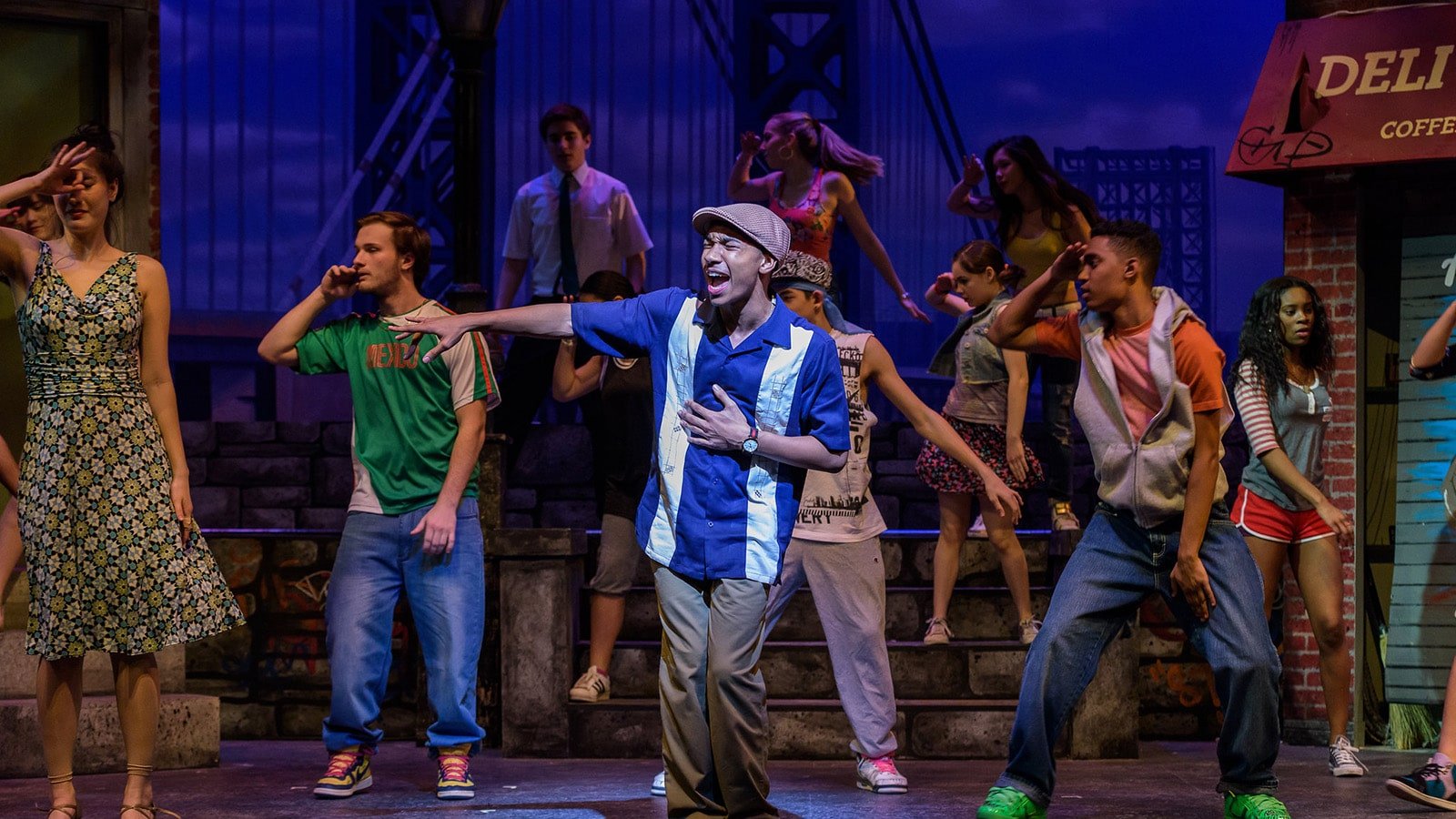 multiple actors on stage performing in a musical