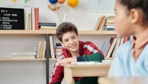 Student sitting at a desk, smiling