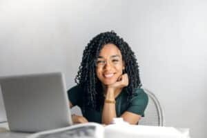 A young person sitting at a laptop