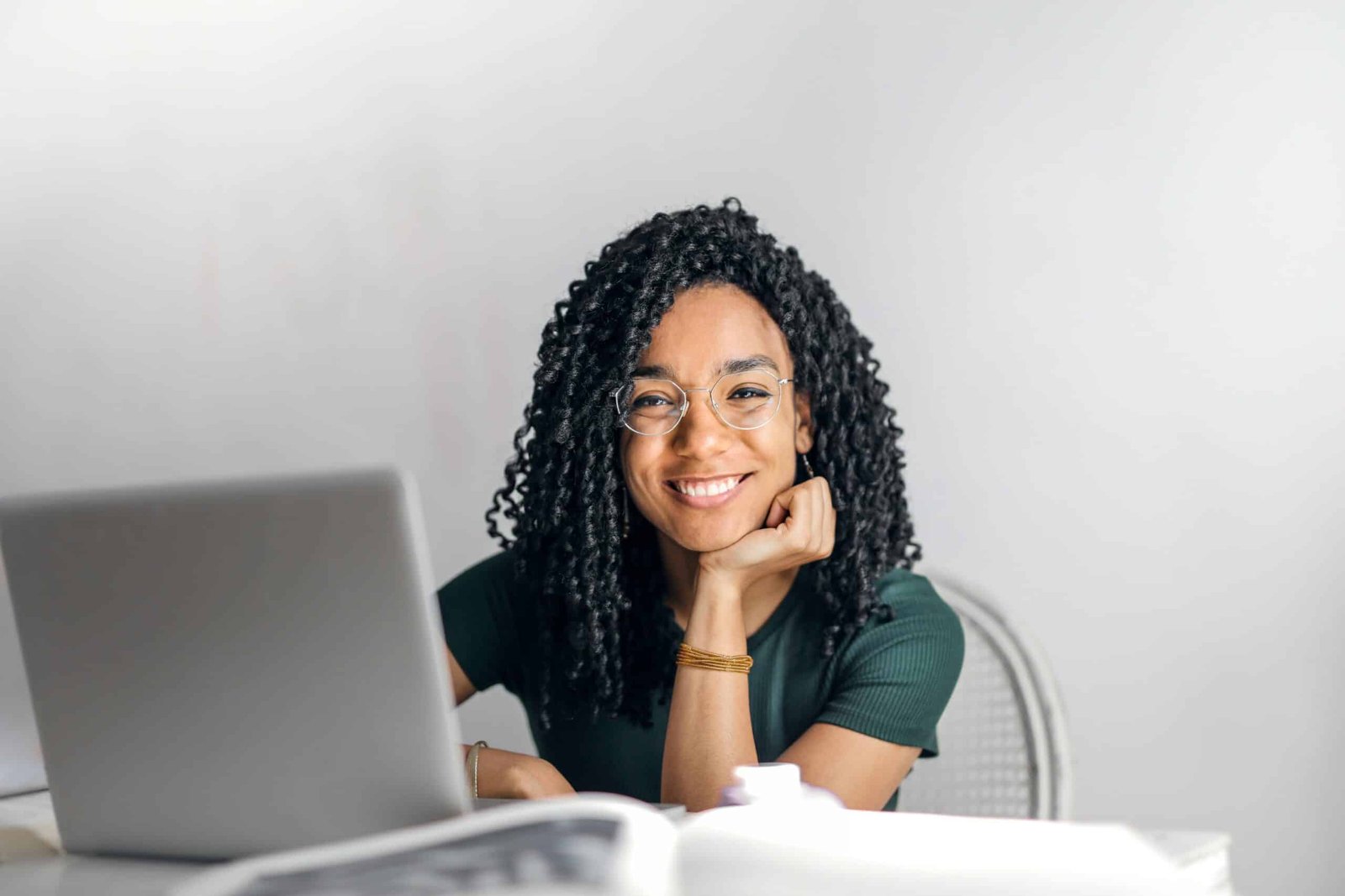 A young person sitting at a laptop